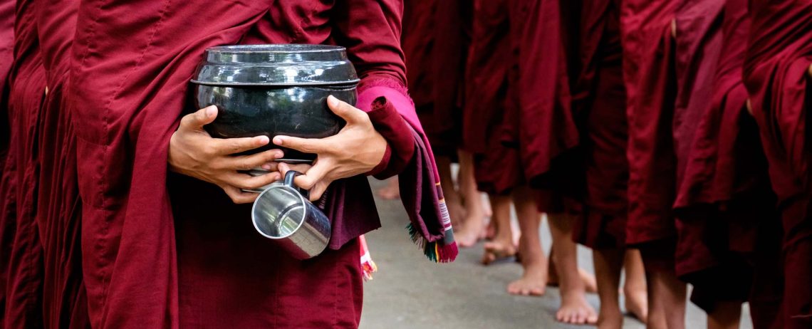 detail-of-buddhist-monks-crowd-and-person-holding-PKCY67V.jpg